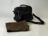 a purse and a wallet sitting on a white surface