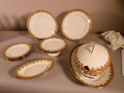 a lot of plates and bowls that are on a table