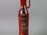a red vase with a picture of a woman on it