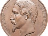 an image of a bronze medal with a man ' s face on it