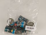 several cans of soda sitting in a bag on top of a table