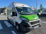 a green and white van parked in a parking lot