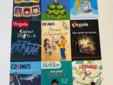 several children ' s books are lined up on a white surface