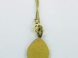 a close up of a gold necklace on a white surface