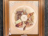 an old picture of a clock with a picture of a cat on it