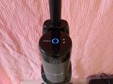 a vacuum that is sitting on a table next to a cell phone