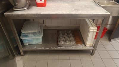a kitchen with a sink and a counter with muffins on it