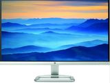 the computer monitor is on a stand with a mountain view in the background