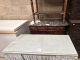 a table with a chair and a dresser in a room