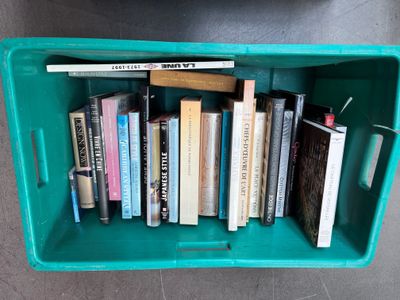 a green box with a bunch of books inside of it