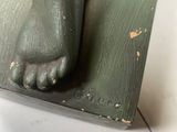a statue of a cat that is sitting on top of a table