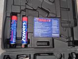 a tool kit in a case with a hammer and two batteries