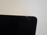 a black laptop with a cracked screen on a table