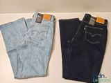 two pairs of levi ' s jeans are sitting on a table