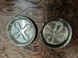 two metal pans sitting on a wooden table