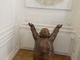 a statue of a bear sitting in a corner of a room