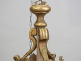a gold colored chandelier with a bird on top of it
