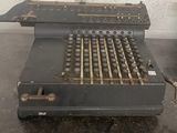 an old typewriter sitting on a table in a room