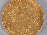 a close up of a gold coin on a white surface