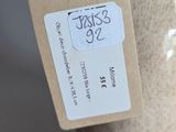 a white vase with a tag attached to it