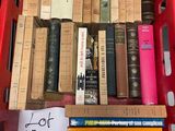 many books in a red basket on the table
