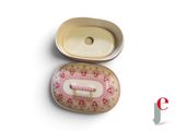 a small box with a pink and white design on it