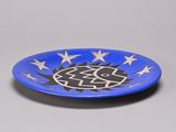 an image of a blue plate with stars and a fish on it