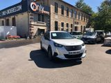 a white car parked in front of a building in a parking lot