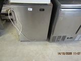two refrigerators sitting next to each other in a room
