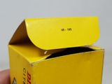 someone is holding a yellow box with a black cat inside of it