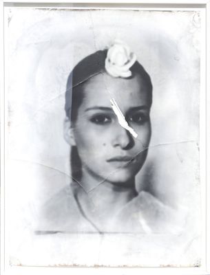 a black and white photo of a woman with a flower in her hair