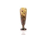 a glass vase with flowers on it on a white surface