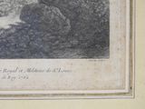 an old picture of a woman sitting on a rock