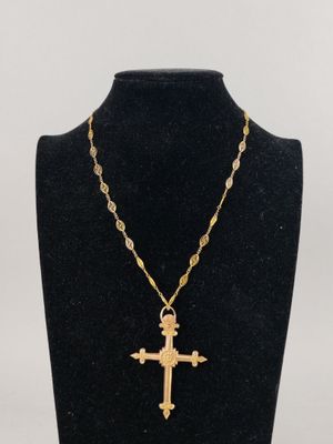 a necklace with a cross on a mannequin neck