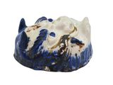 a blue and white bowl with a cat head on it