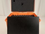 an orange and black case sitting on top of a white table