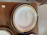three plates and a bowl sitting on a table