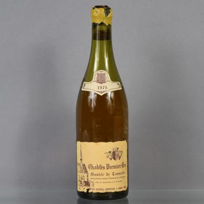 an old bottle of wine sitting on top of a glass table