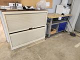 an image of a garage with a desk and a refrigerator