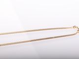 a close up of a gold chain on a white background