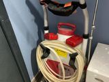 an image of a vacuum and a hose in a room
