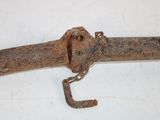 an old rusted metal object with a chain hanging from it ' s end