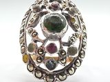 an image of a silver ring with multi colored stones on it