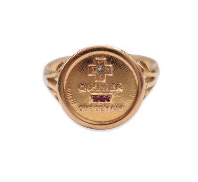 a close up of a gold ring with a coin on it