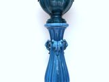 a blue vase sitting on top of a table
