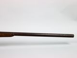 a close up of a wooden baseball bat on a white surface