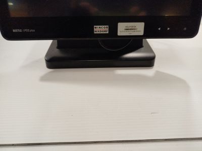 a small monitor on a stand on a table