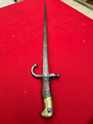 an old sword on a red table cloth