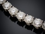 a diamond necklace on a black background