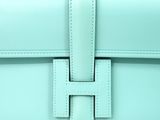 a close up of a light blue purse with a metal clasp